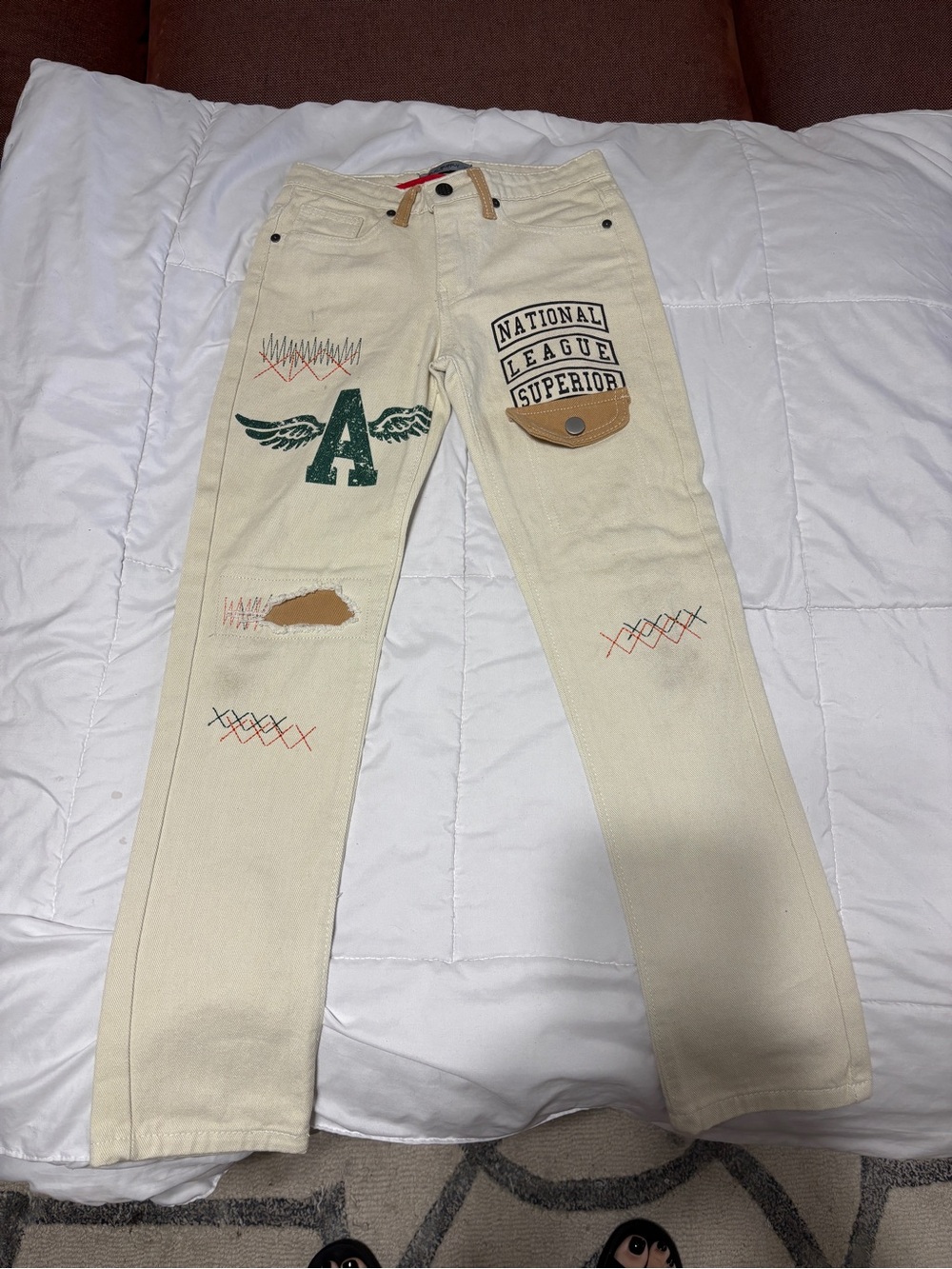Cream Jeans with Green 'A' Wing Graphic and Tan Patch